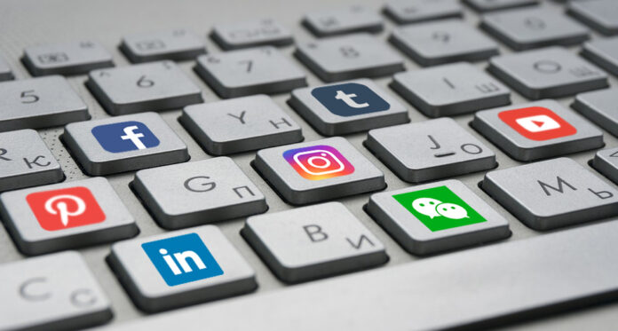 Keyboard keys with different social media logos.
