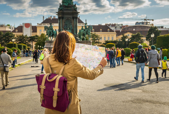 Woman traveling alone looking at a map.